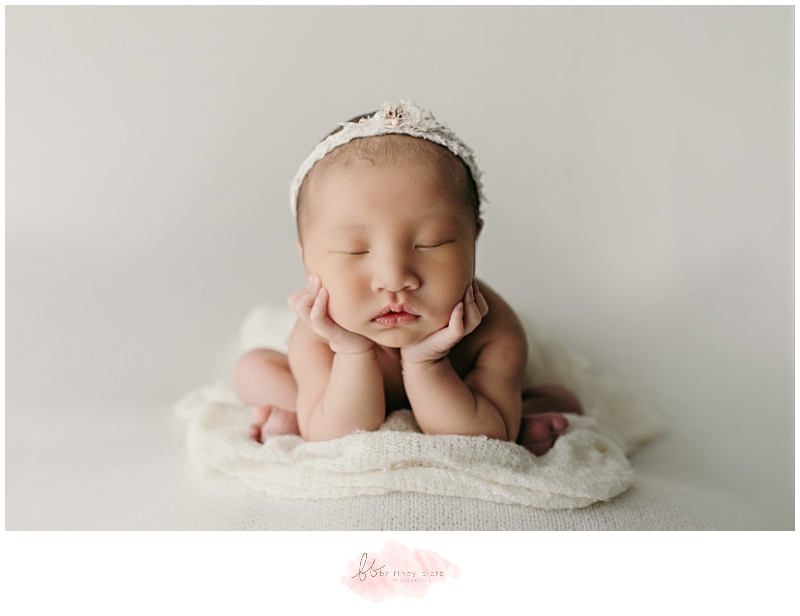 Calgary newborn photo baby girl in froggy pose from the front