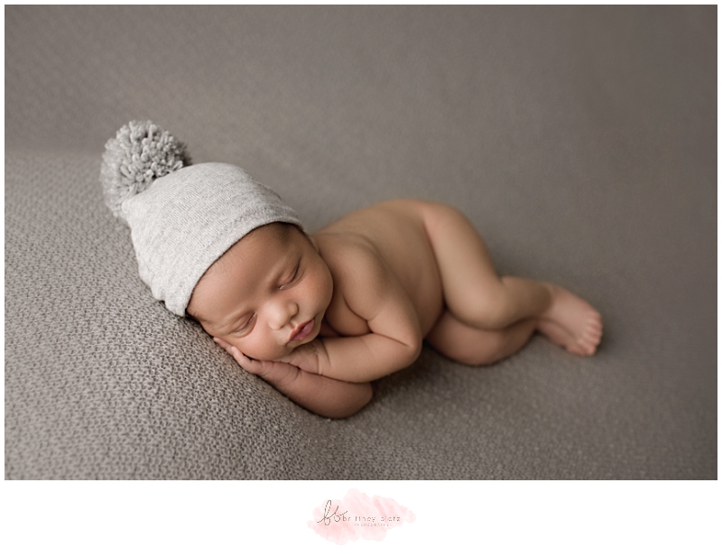 Calgary newborn photographer baby boy laying down on grey