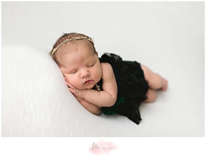 Calgary Newborn Photographer baby girl side laying on hands