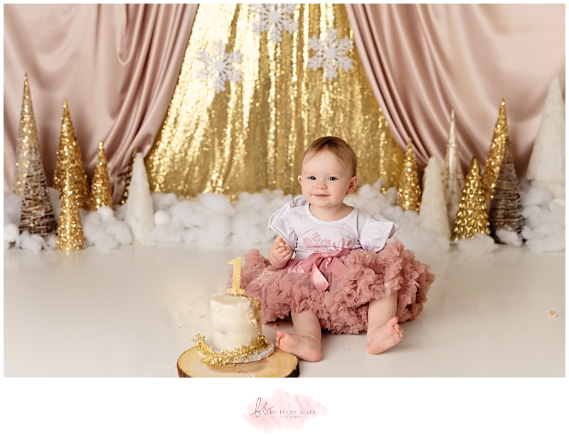 Calgary winter-themed cake smash baby eating cake in pink tutu