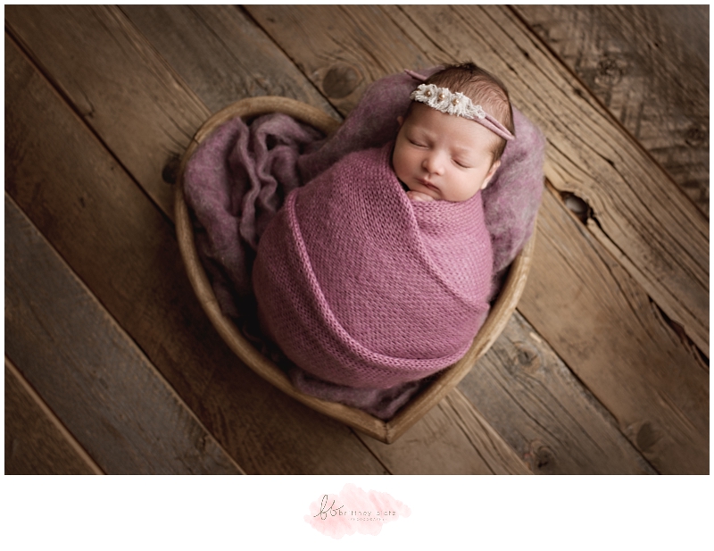 Calgary Newborn Photographer baby girl in heart bowl and purple wrap