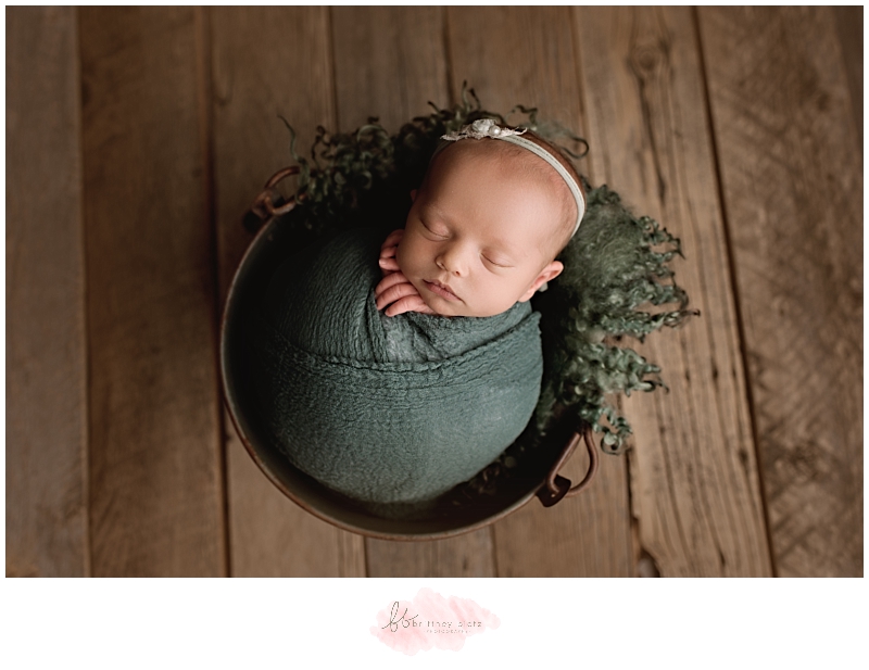 Calgary Newborn Photographer baby girl in green bucket